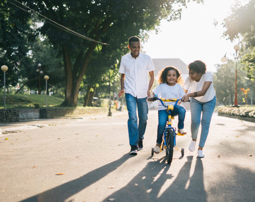 family with kid on a bike